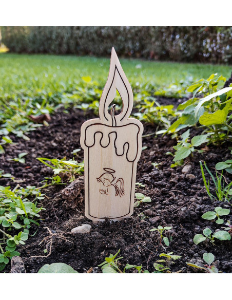 Personalized wooden memorial candle placed at a gravesite