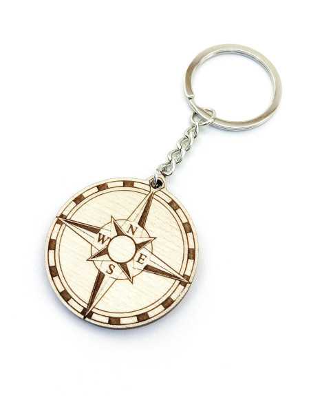 Compass-themed keychain with engraved travel design