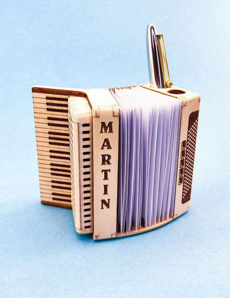 Wooden desk organizer shaped like a piano accordion with pen and note holder.