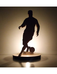 Wooden candle holder featuring a football player dribbling 2