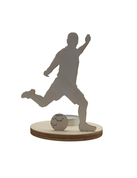Wooden candle holder of a football player kicking a ball