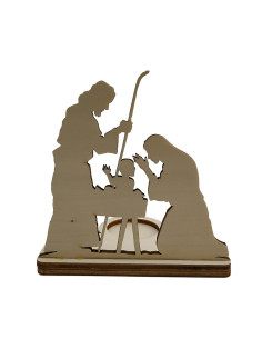 Wooden nativity candle holder casting shadows of Mary, Joseph, and baby Jesus