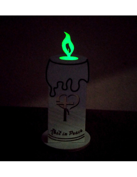 Wooden remembrance candle glowing softly in the dark