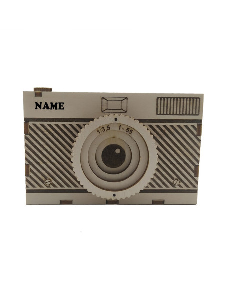 Wooden camera-shaped pen holder with personalised name engraving and lens detail.