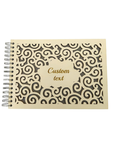 Close-up of personalized photo album with cloud pattern design and engraved text