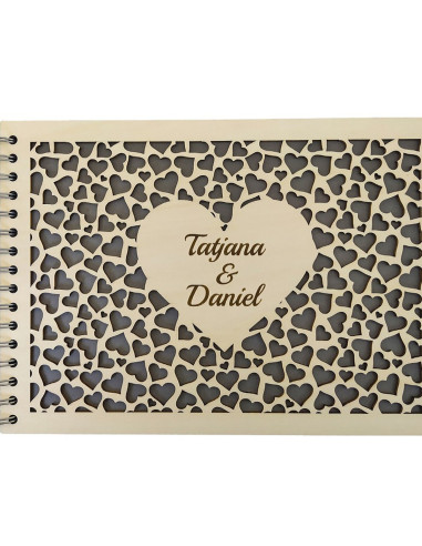 Close-up of personalized heart photo album with engraved couple's names