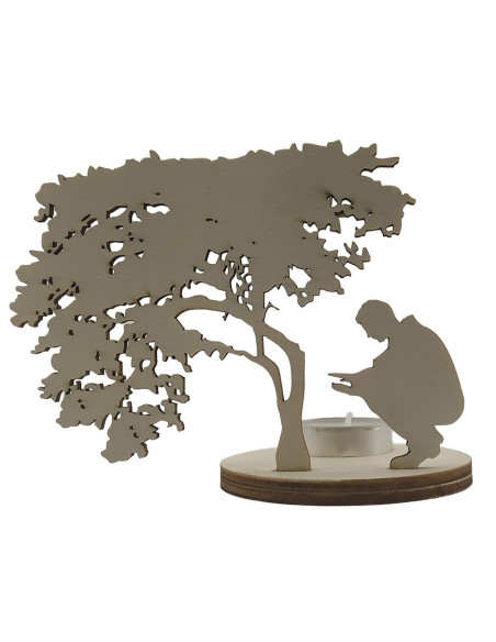 Candle holder silhouette showing a peaceful figure beside a tree