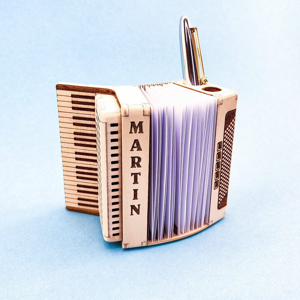 wooden desk organizer shaped like a piano accordion with engraving